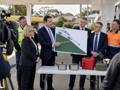 Government officials present a downhill driving plan at a petrol station