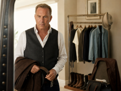 Kevin Costner solemnly getting ready in a dressing room for a fictional satire story