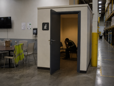 Warehouse breakroom beside a small quiet room and storage shelving